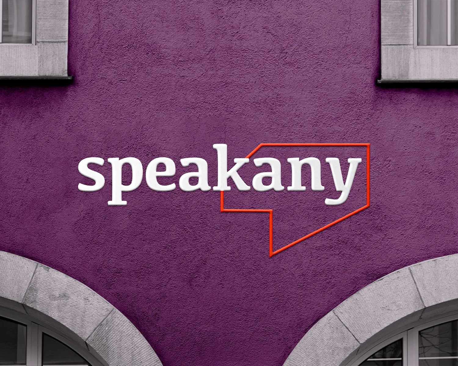 Speakany sign on a purple wall